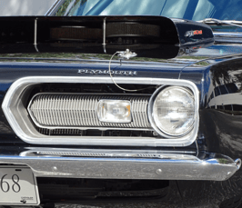 alt="Front headlight of a 1968 Plymouth Barracuda"