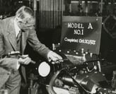 alt="Picture of Henry Ford working on a vintage vehicle"