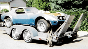alt="1969 Chevrolet Corvette Stingray on trailer, full of debris"