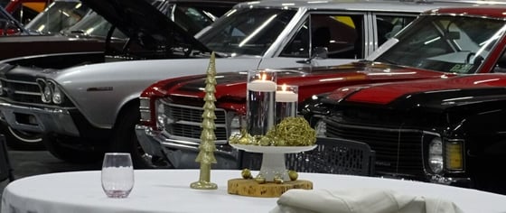 alt="A Christmas table centerpiece with vehicles in the background"