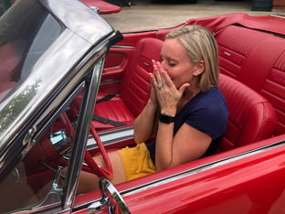 alt="woman excited about sitting in new vintage vehicle"
